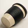 Beige reusable coffee cup with black band and lid. Band embossed with the AA logo