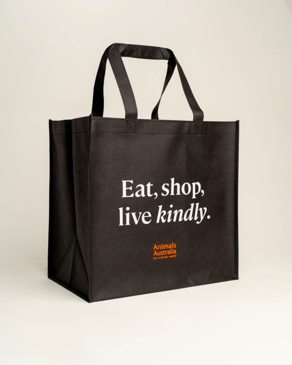 Black shopper bag with orange Animals Australia logo and a quote - "Eat, shop, live kindly"